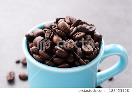 Coffee cup and dark roasted coffee beans Coffee cup and dark roasted coffee beans 128455368