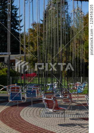 Children's carousels and swings in the amusement park 128456105