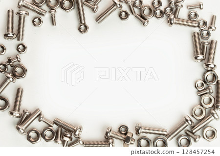 Stainless Steel Nuts and Bolts on White Background Stainless Steel Nuts and Bolts on White Background 128457254