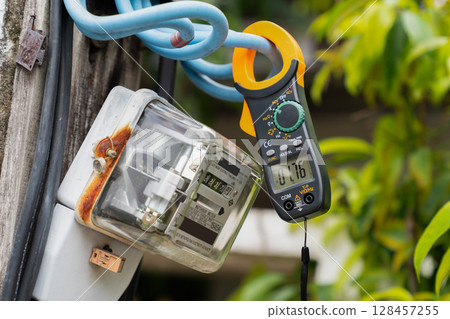 Outdoor Voltage Testing with Digital Clamp Meter 128457255
