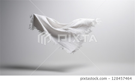 A cotton towel that has been torn diagonally and the fibers have come apart 128457464
