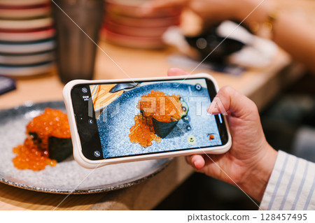 Smartphone Food Photography of Gourmet Sushi with Salmon Roe 128457495