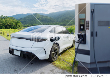 Electric car is charging in power station 128457498