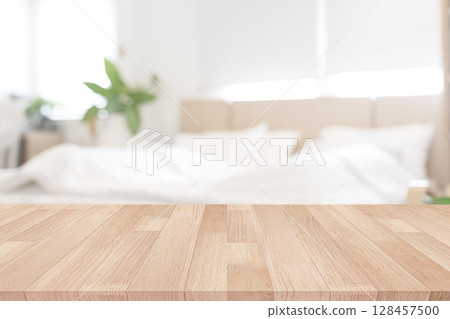 Wooden Table in Cozy Bedroom Background 128457500