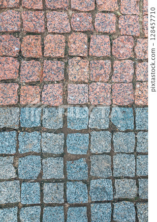 Red blue old paving stones. Texture paving stones. Stone mosaic 128457710
