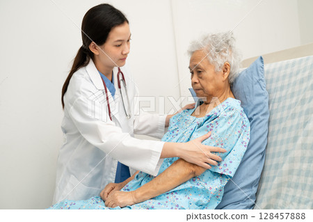 Asian doctor checking and treat elderly woman patient health in hospital. Asian doctor checking and treat elderly woman patient health in hospital. 128457888