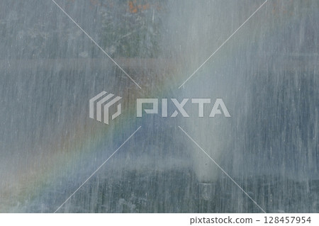 Fountain and rainbow in the park 128457954