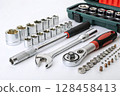 Socket wrench set with ratchets and accessories on white background. 128458413
