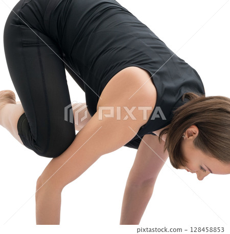 Woman doing handstand in studio isolated shot Woman doing handstand in studio isolated shot 128458853