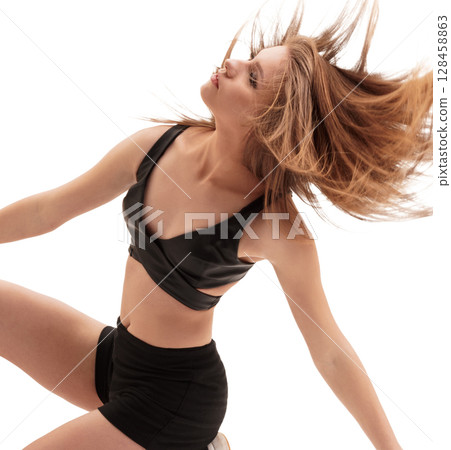 Sporty blonde in black top, shorts and sneakers Sporty blonde in black top, shorts and sneakers 128458863