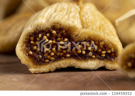 cut into pieces of dried figs used in cooking, light-colored figs with lots of seeds naturally dehydrated in the sun and cut into pieces 128459352