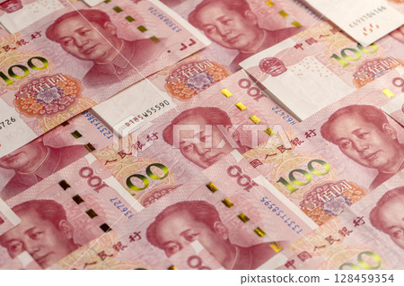 Chinese money of one hundred yuan , the obverse of genuine Chinese yuan money stacked on top of each other, close up 128459354