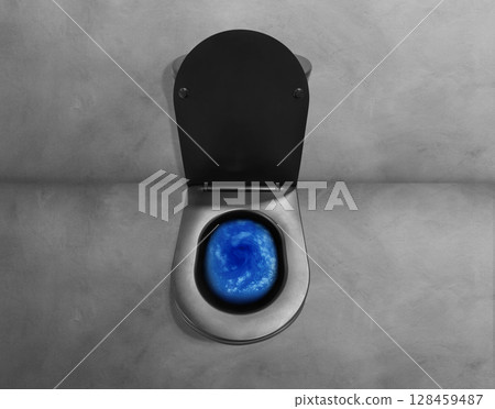 Top view toilet bowl, blue detergent being flushed into the bowl. 128459487