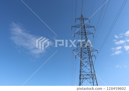 Tower rising in the blue sky 128459602