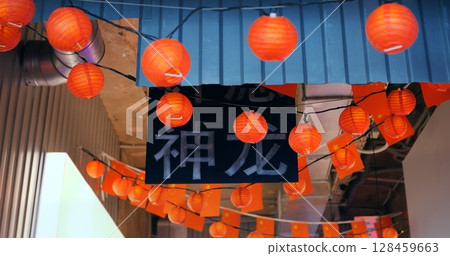 Vibrant red lanterns and flags adorning corridor ceiling, creating festive atmosphere for traditional chinese new year celebration with cultural signage Vibrant red lanterns and flags adorning corridor ceiling, creating festive atmosphere for traditional chinese new year celebration with cultural signage 128459663