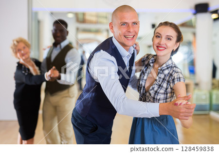 Man and woman dancing waltz in studio Man and woman dancing waltz in studio 128459838