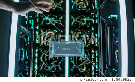 Close up of a technician's hands installing a transparent quantum computing chip into a futuristic supercomputer, showcasing intricate wiring and glowing lights 128459922