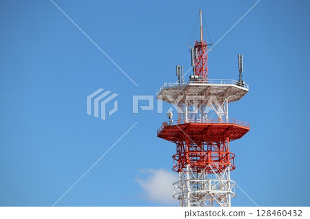 Radio tower towering in the blue sky 128460432