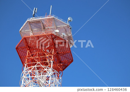 Radio tower towering in the blue sky Radio tower towering in the blue sky 128460436