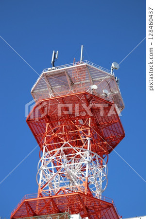 Radio tower towering in the blue sky Radio tower towering in the blue sky 128460437