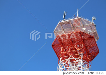 Radio tower towering in the blue sky Radio tower towering in the blue sky 128460438