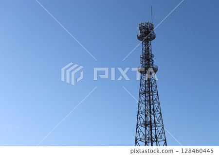 Radio tower towering in the blue sky Radio tower towering in the blue sky 128460445