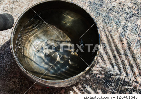 Meditative Sound Bowl. A sound bowl with water reflecting 128461643