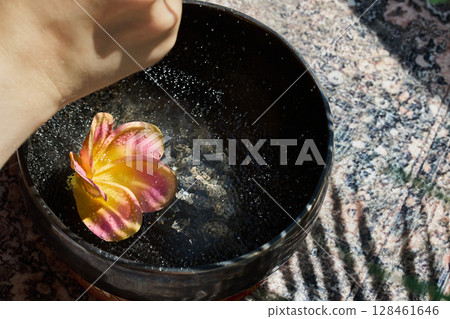 Serene Singing Bowl with Flower Serene Singing Bowl with Flower 128461646
