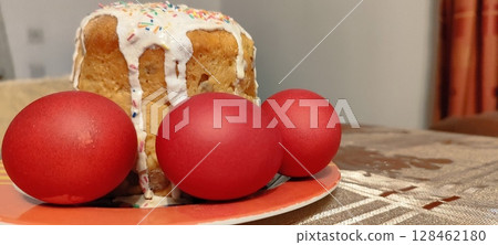 Traditional Easter cake with sprinkles and icing. Red eggs with Easter cake. Traditional Easter cake with sprinkles and icing. Red eggs with Easter cake. 128462180