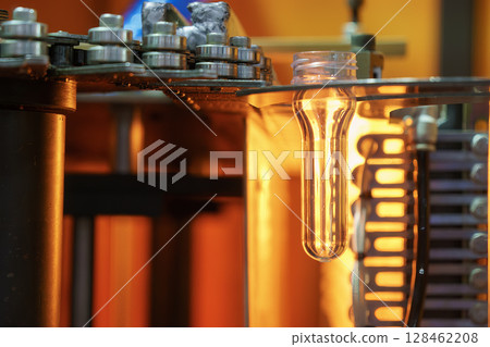 The drinking water bottle manufacturing process by blow mold machine. 128462208