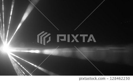 Black-and-white laser beams radiating from a blinding light source in the dark 128462230