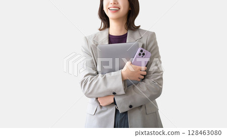 Smiling woman with a laptop and smartphone 128463080