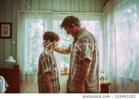 A man and a boy are standing in a room 128463201