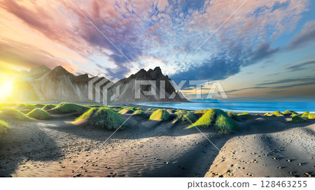 Impressive sunset with gorgeous black sand dunes on Stokksnes cape in Iceland. 128463255
