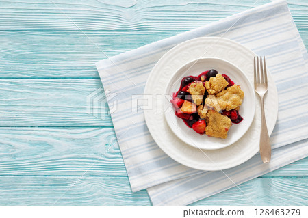 apple blueberry strawberry crumble on white plate 128463279
