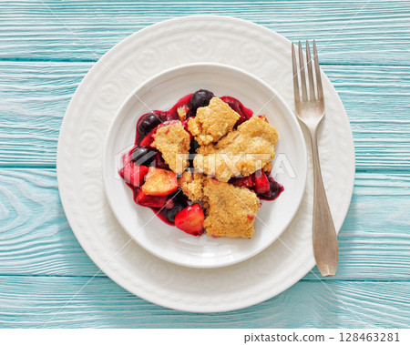 apple blueberry strawberry crumble on white plate 128463281