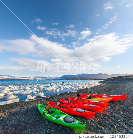 Impressive Kayaks on the shore of Jokulsarlon glacier lagoon at sunset. Impressive Kayaks on the shore of Jokulsarlon glacier lagoon at sunset. 128463294