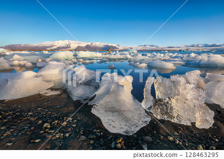 Ramarkable landscape with floating icebergs in Jokulsarlon glacier lagoon at sunset. Ramarkable landscape with floating icebergs in Jokulsarlon glacier lagoon at sunset. 128463295