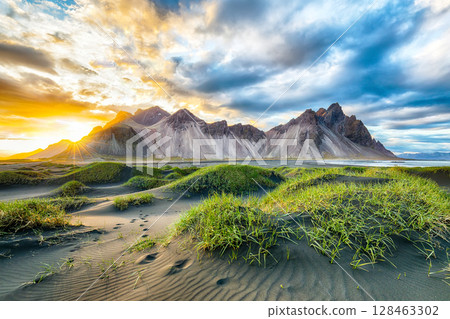 Remarkable sunset with gorgeous black sand dunes on Stokksnes cape in Iceland. Remarkable sunset with gorgeous black sand dunes on Stokksnes cape in Iceland. 128463302