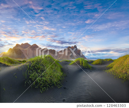 Remarkable sunset with gorgeous black sand dunes on Stokksnes cape in Iceland. Remarkable sunset with gorgeous black sand dunes on Stokksnes cape in Iceland. 128463303