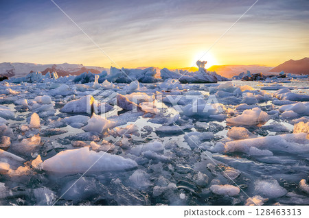 Ramarkable  landscape with floating icebergs in Jokulsarlon glacier lagoon at sunset. 128463313