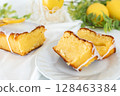 Lemon cake cut and presented in its entirety (on a white plate and in natural light) 128463384