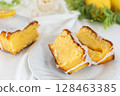 Cross section of a cut lemon cake (fluffy baked confectionery, white background) 128463385