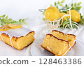 Lemon cake cut and presented in its entirety (on a white plate and in natural light) 128463386