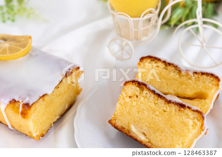 Cross section of a cut lemon cake (fluffy baked confectionery, white background) Cross section of a cut lemon cake (fluffy baked confectionery, white background) 128463387