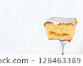 Partly eaten lemon cake (with fork/natural lighting) 128463389