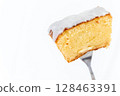 Iced lemon cake lifted with a fork 128463391