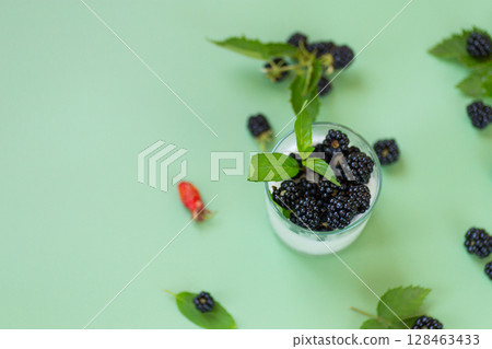 Cold milk yoghurt with berries and greens on the background 128463433