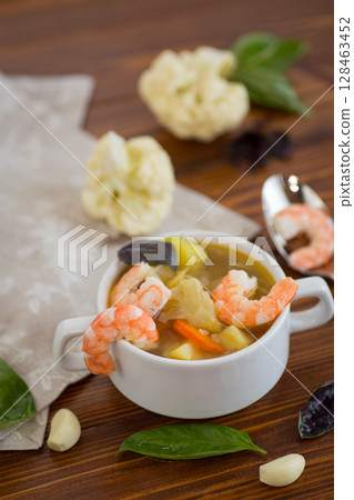 A White Cup of Warm Broth with Large Juicy Shrimp A White Cup of Warm Broth with Large Juicy Shrimp 128463452