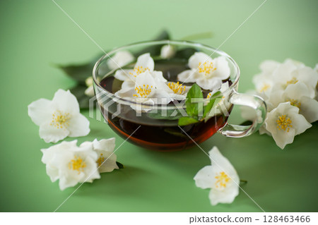Green tea with jasmine in a glass teapot from above Green tea with jasmine in a glass teapot from above 128463466